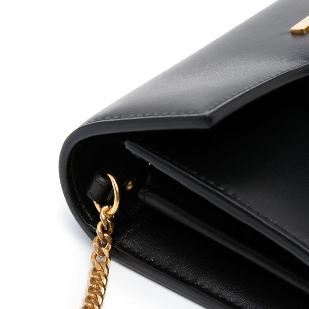 Black handbag with a gold chain on a white background