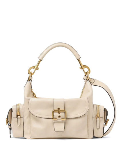 Beige handbag with gold accents on a white background