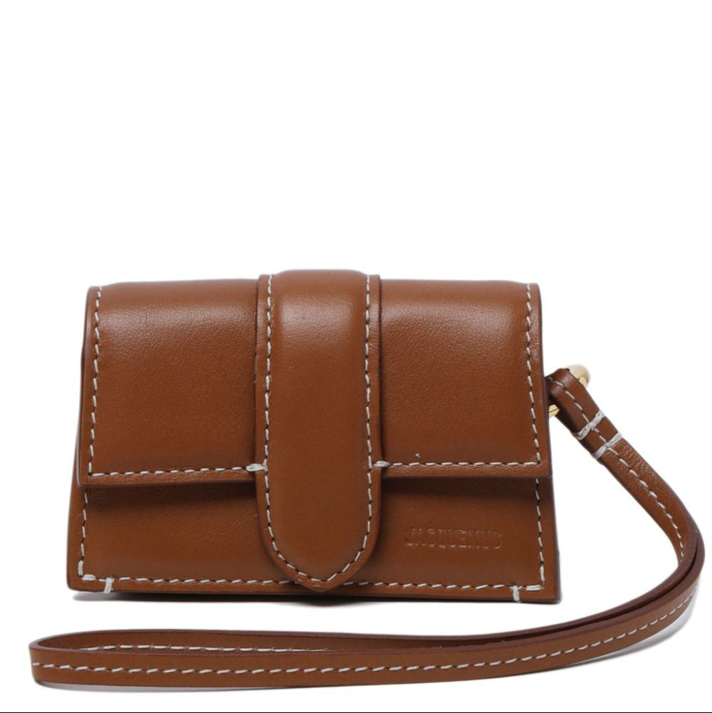 Brown leather wallet with a strap on a white background