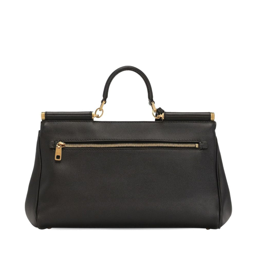 Black handbag with gold accents on a white background