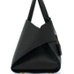 Black handbag with a unique design on a white background