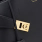 Black handbag with gold lock detail and Ferragamo branding