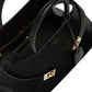 Black handbag with gold clasp on a white background