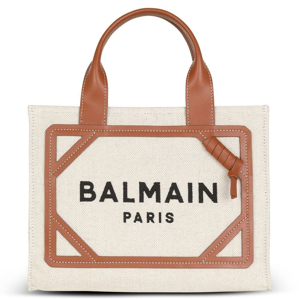 Balmain Paris tote bag with brown leather handle and trim on a white background