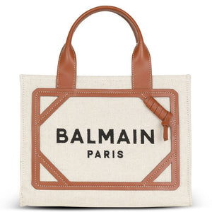 Balmain Paris tote bag with brown leather handle and trim on a white background