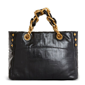 Black handbag with gold chain handle on a white background