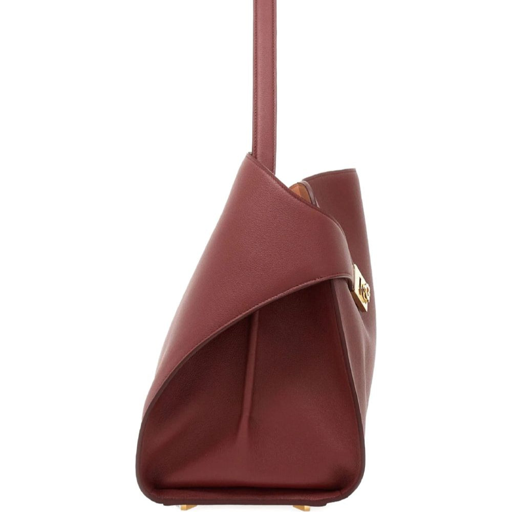 Maroon handbag with a gold clasp on a white background