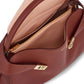 Brown leather handbag with gold zipper and visible brand logo on a white background