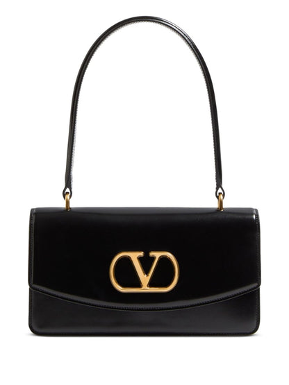 Black handbag with gold logo on a white background