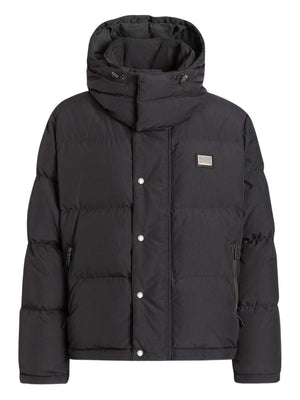 Black puffer jacket with a brand logo on a white background