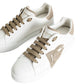 White sneakers with beige laces and accents on a white background