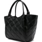 Black quilted handbag on a white background