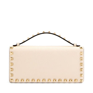 Beige handbag with gold studs on a white background