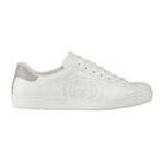 White sneaker with a brand logo on a light gray background
