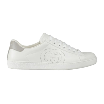 White sneaker with a brand logo on a light gray background