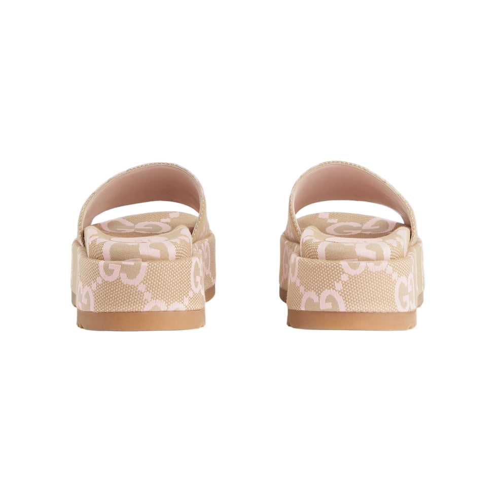 Pair of beige and white patterned sandals on a light gray background