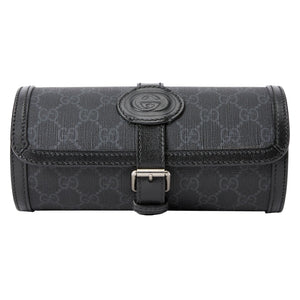 Black Gucci toiletry bag with monogram pattern on a light gray background