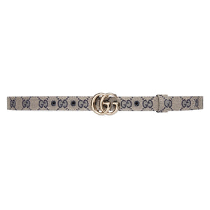 Designer belt with a patterned strap and gold buckle on a light gray background
