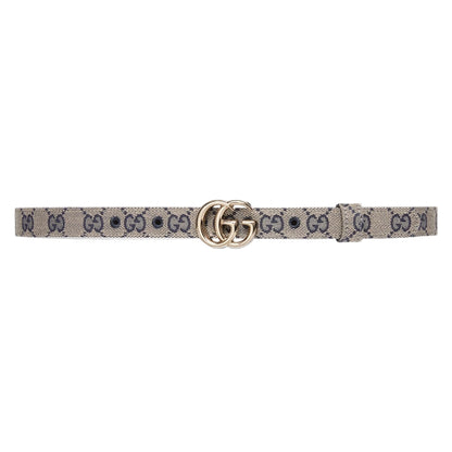 Designer belt with a patterned strap and gold buckle on a light gray background