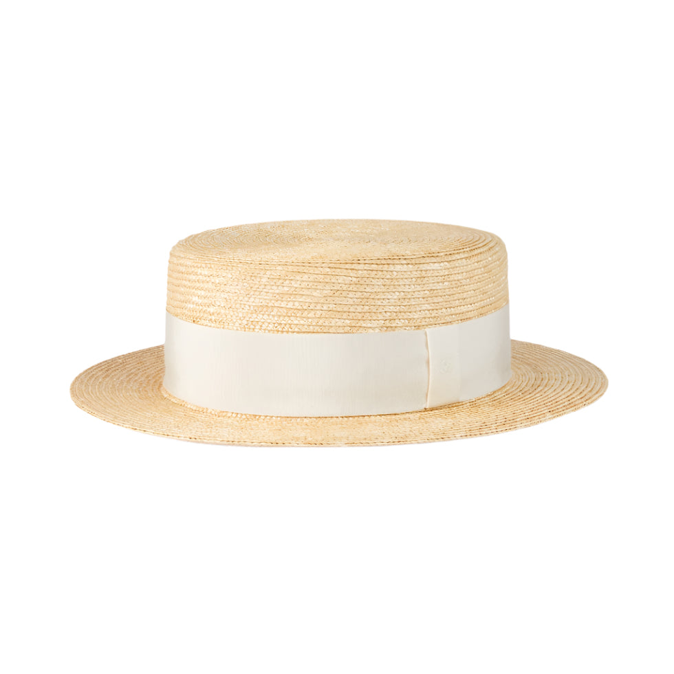 Straw Gucci hat with a white band on a white background
