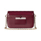 Maroon handbag with gold chain strap on a light gray background