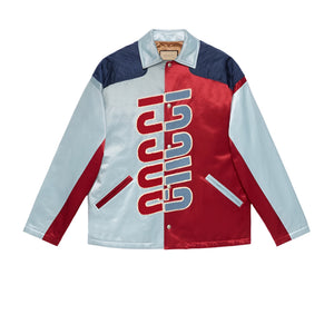 Color-blocked Gucci jacket with red and blue design on a light gray background