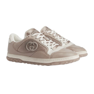 Pair of beige sneakers with a brand logo on a light gray background