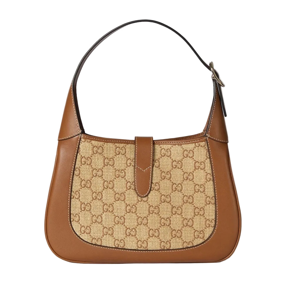 Brown handbag with a patterned flap on a light gray background
