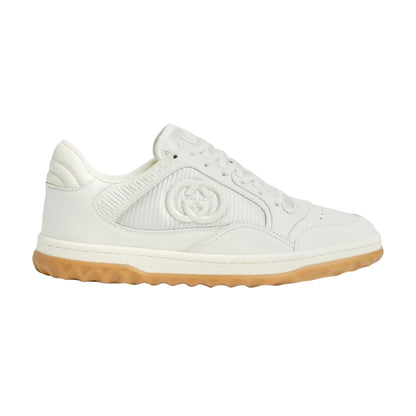 White sneaker with brown sole on a light gray background