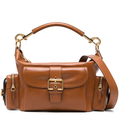 Brown leather handbag with gold accents on a white background