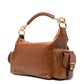 Brown leather handbag with gold accents on a white background