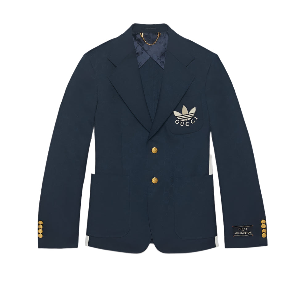 Navy blazer with gold buttons and a logo on a light gray background