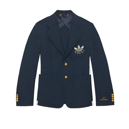 Navy blazer with gold buttons and a logo on a light gray background