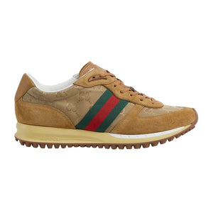 Tan sneaker with green and red striped detail on a light gray background