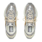 Silver sneakers with beige laces on a white background