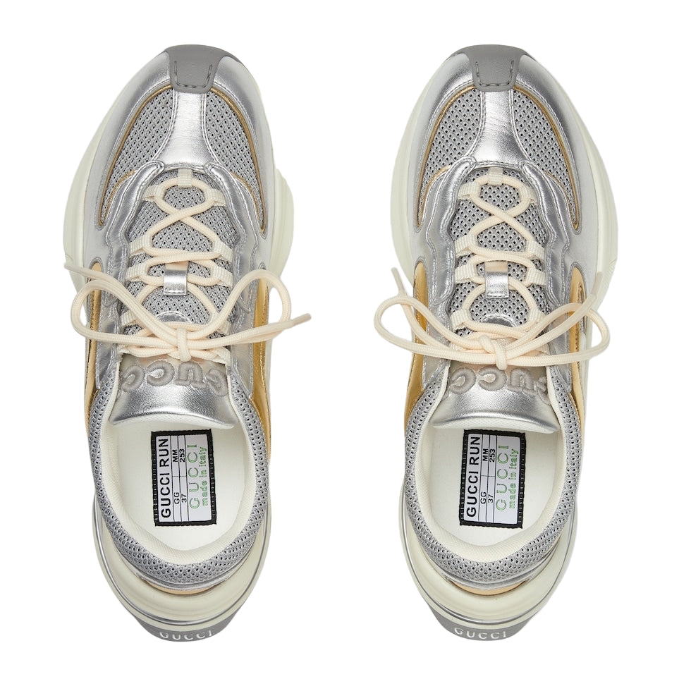 Silver sneakers with beige laces on a white background