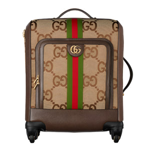 Designer Gucci suitcase with brand jumbo logo and color stripes on a white background