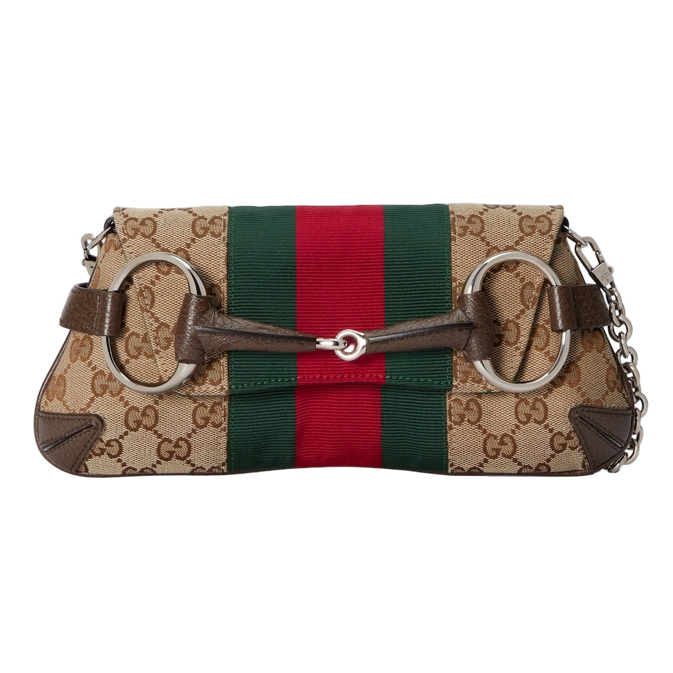 Designer handbag with Gucci logo and color stripe on a light gray background
