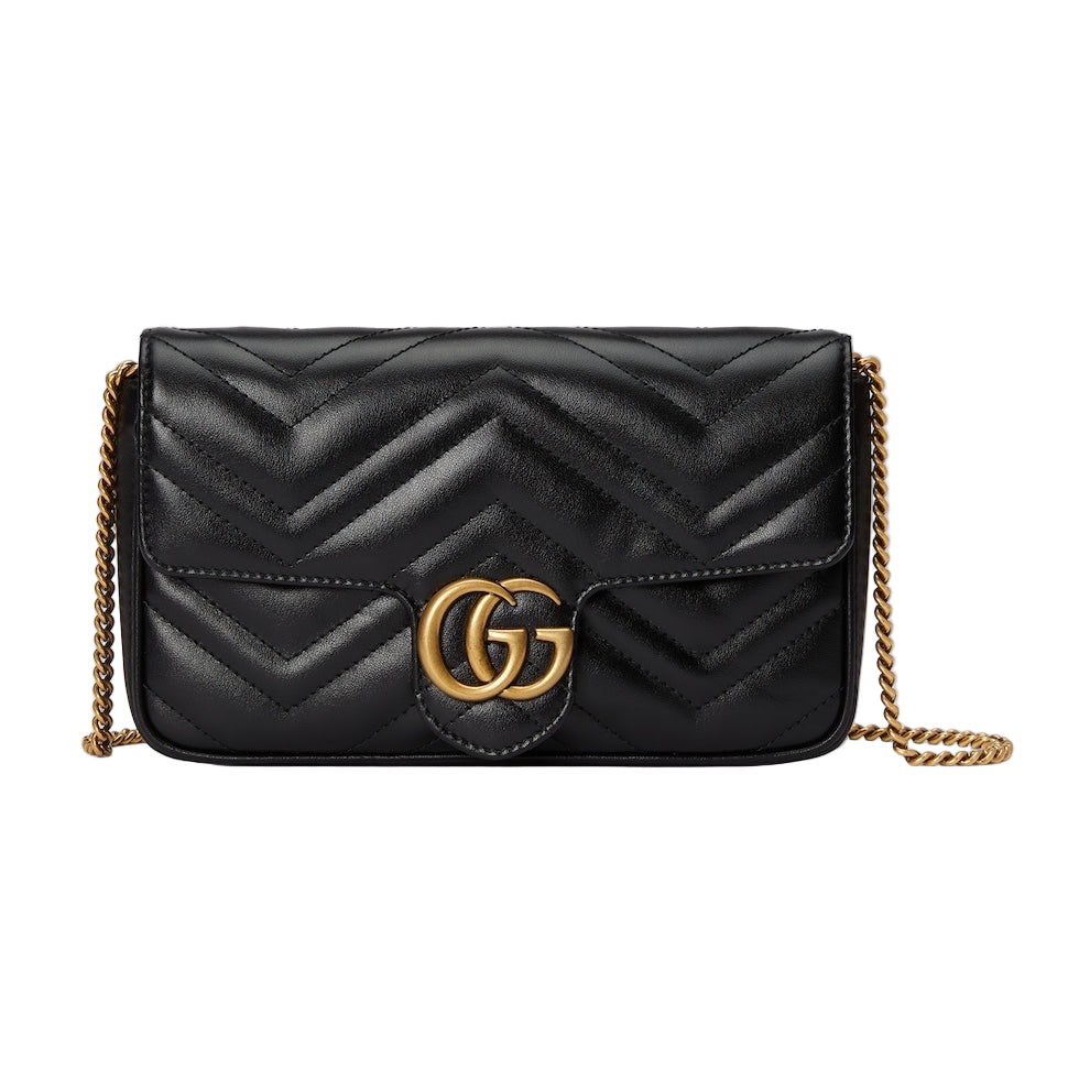 Black quilted handbag with gold chain and Gucci logo on a light gray background
