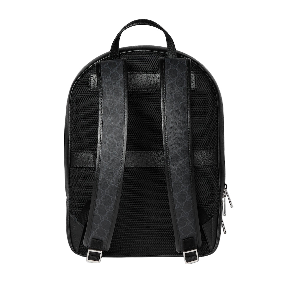Black backpack with patterned straps on a light gray background