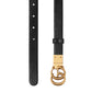 Black belt with a gold buckle on a light gray background