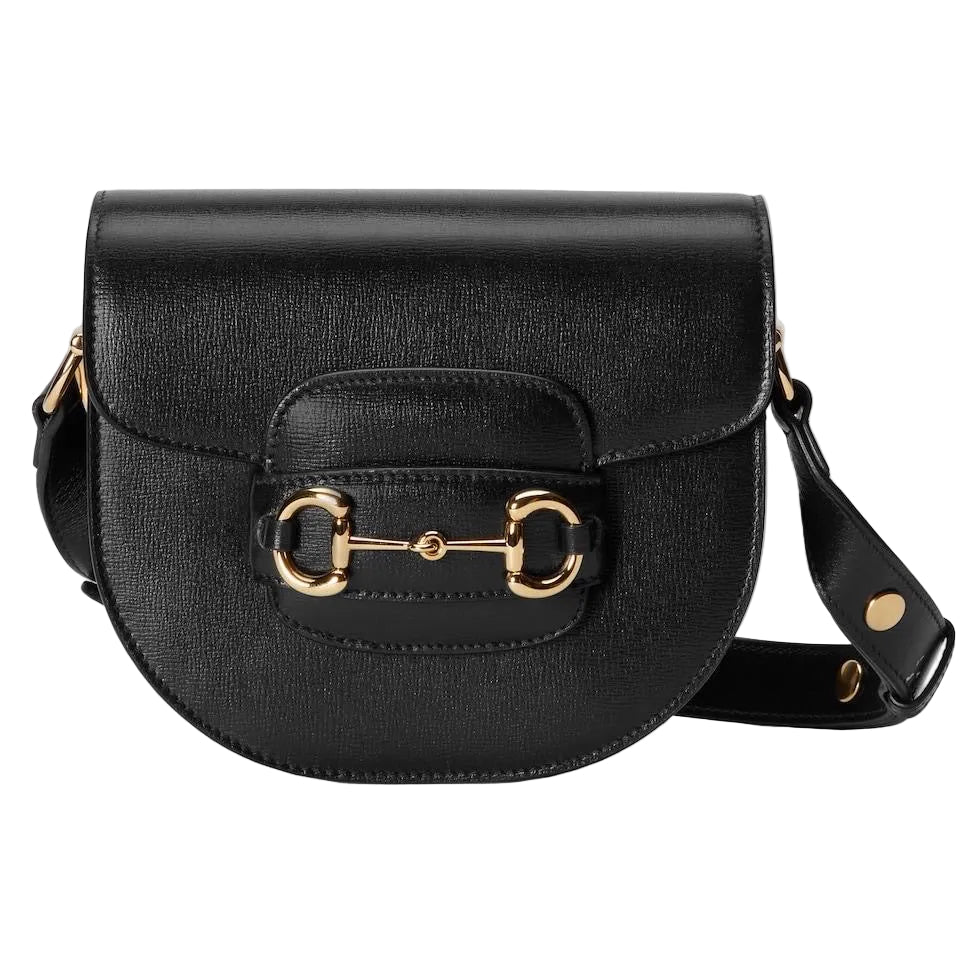 Black saddle bag with gold horsebit detail on a light gray background