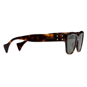 Tortoiseshell sunglasses with Gucci logo on a light gray background