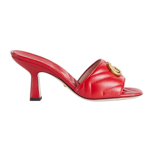 Red high-heeled shoe with a gold buckle on a light gray background