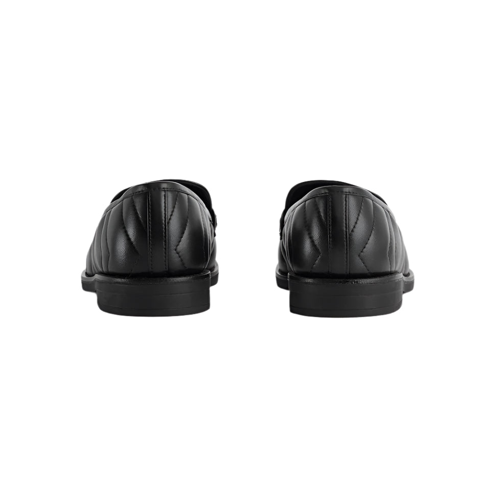 Black leather shoes on a light gray background