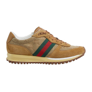Tan sneaker with green and red striped detail on a light gray background