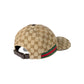 Beige Gucci cap with a green and red stripe on a light gray background