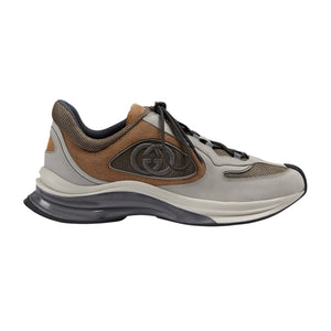 Sneaker with brown and gray design on a light gray background