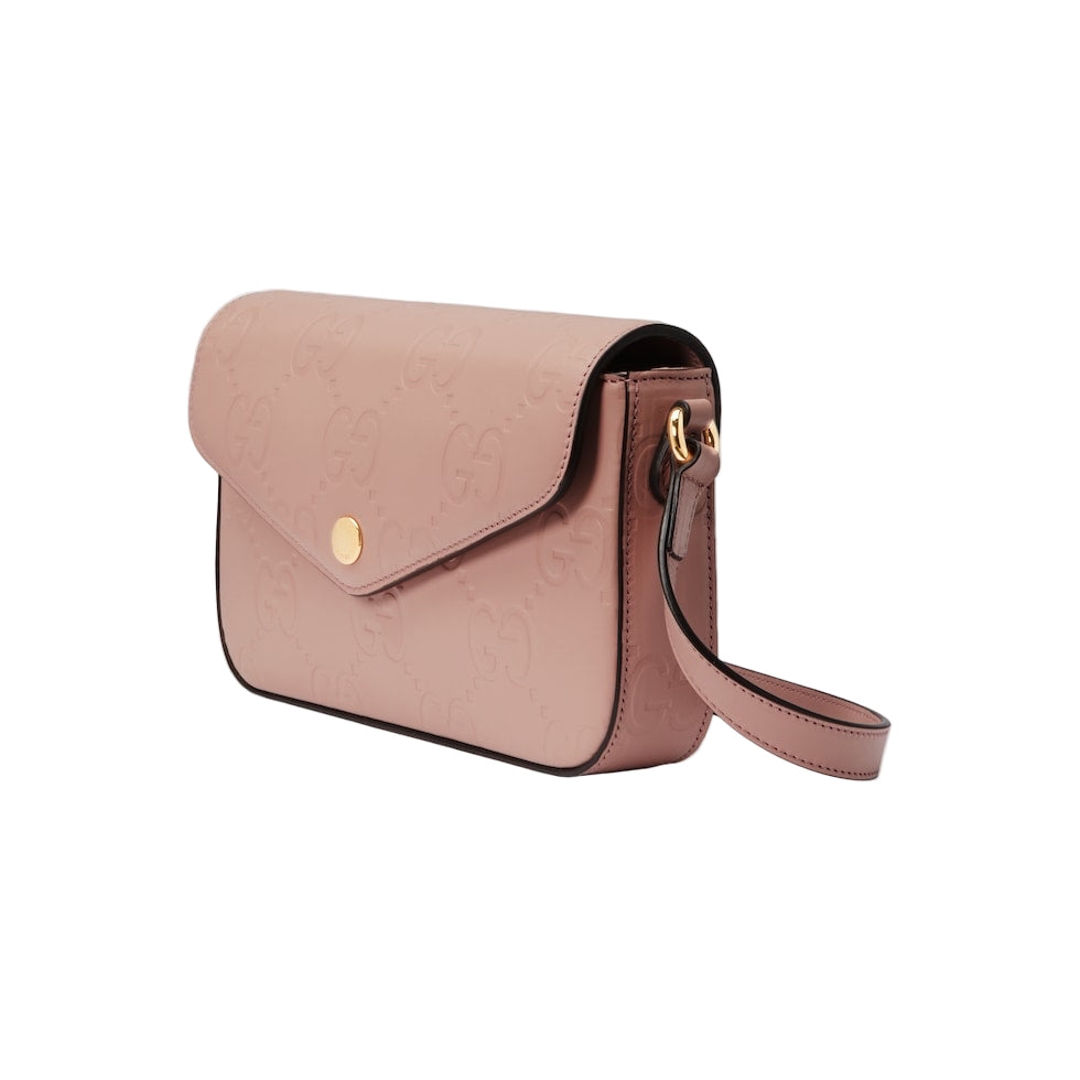 Pink handbag with a gold clasp on a light gray background