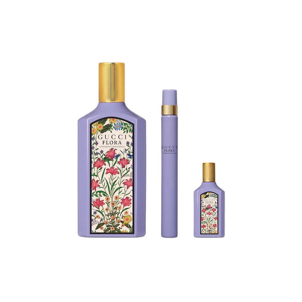 Three Gucci Flora perfume bottles on a light gray background